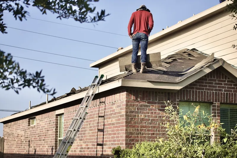 Professional roofer working on a residential roof in Franklin McPherson Square